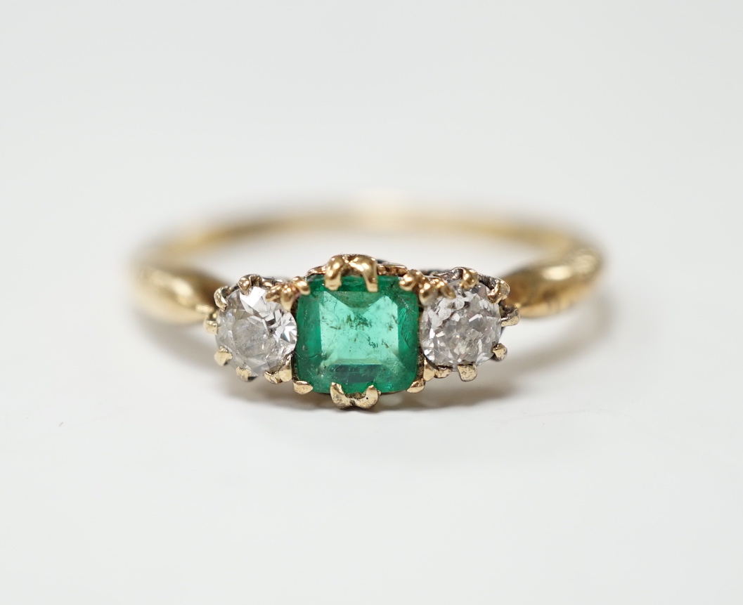 An early to mid 20th century 18ct, emerald and diamond set three stone ring, size O/P, gross weight 2.9 grams.